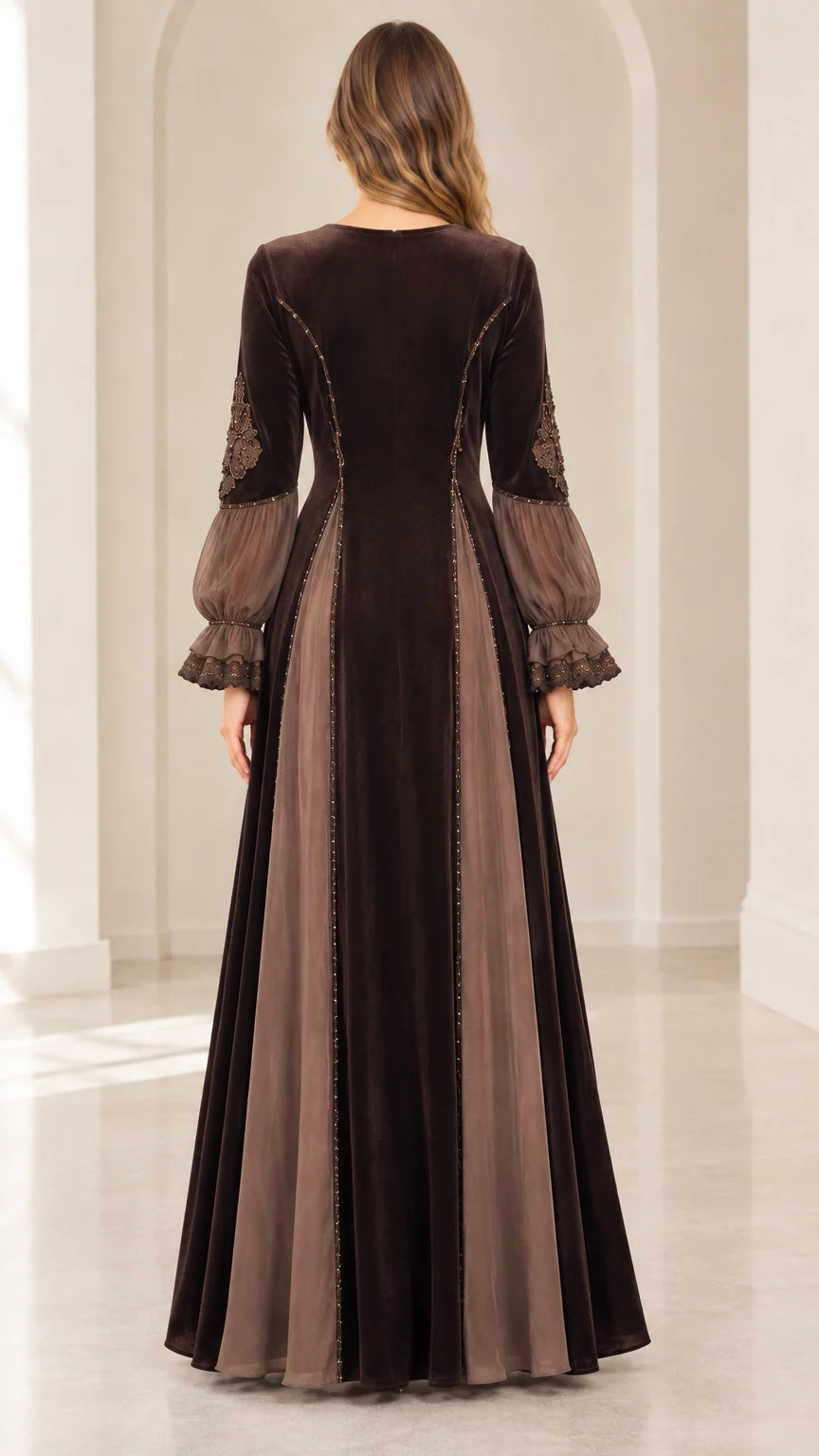 Back view of floor-length brown velvet dress showing flared skirt panels