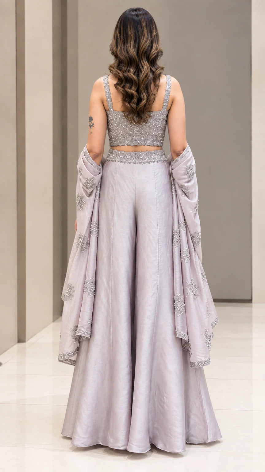 Back full-length view of woman showing fitted back crop top and palazzo trousers in Silver Grey
