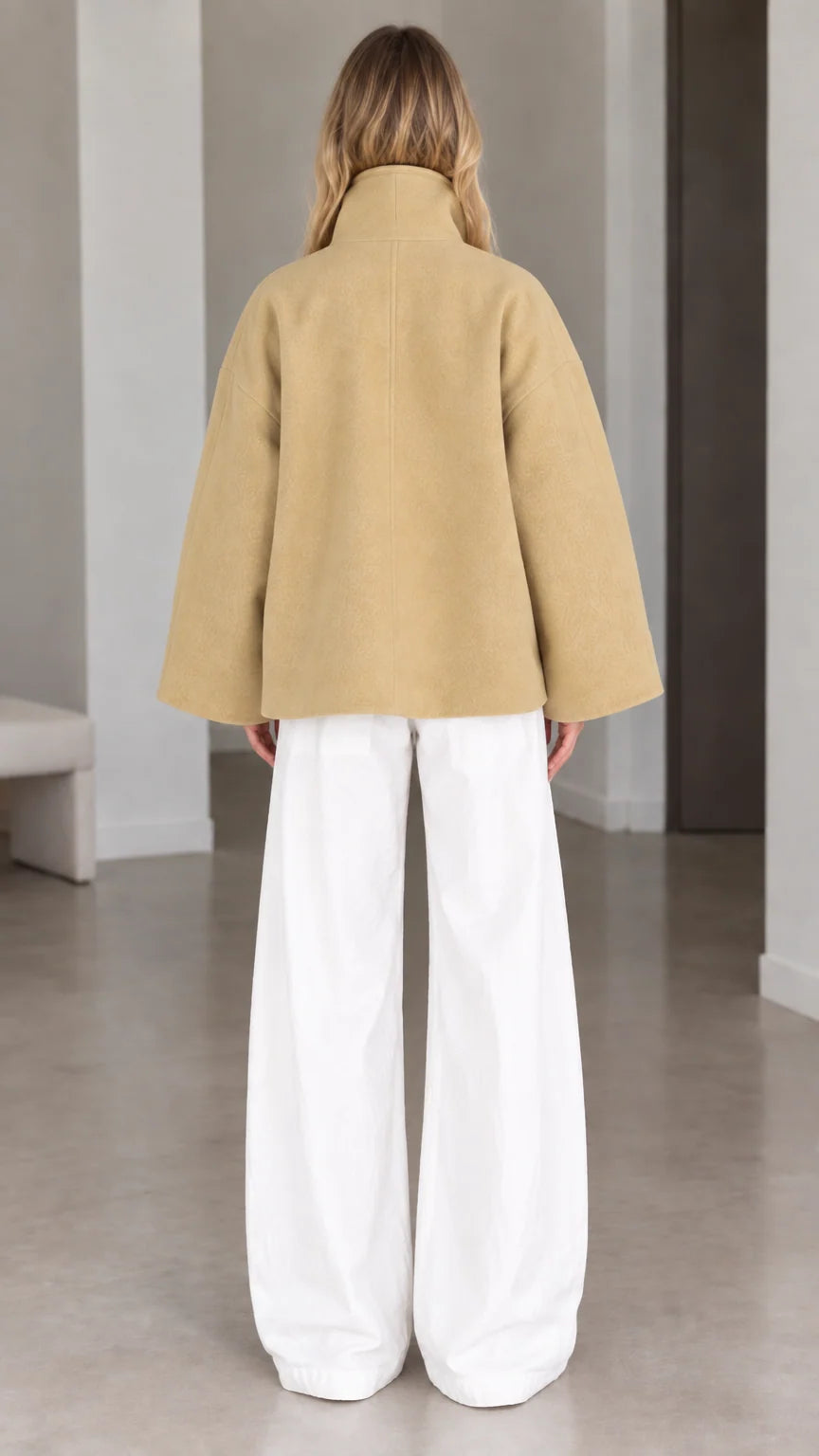 Back view of model wearing relaxed camel batwing sleeve short jacket