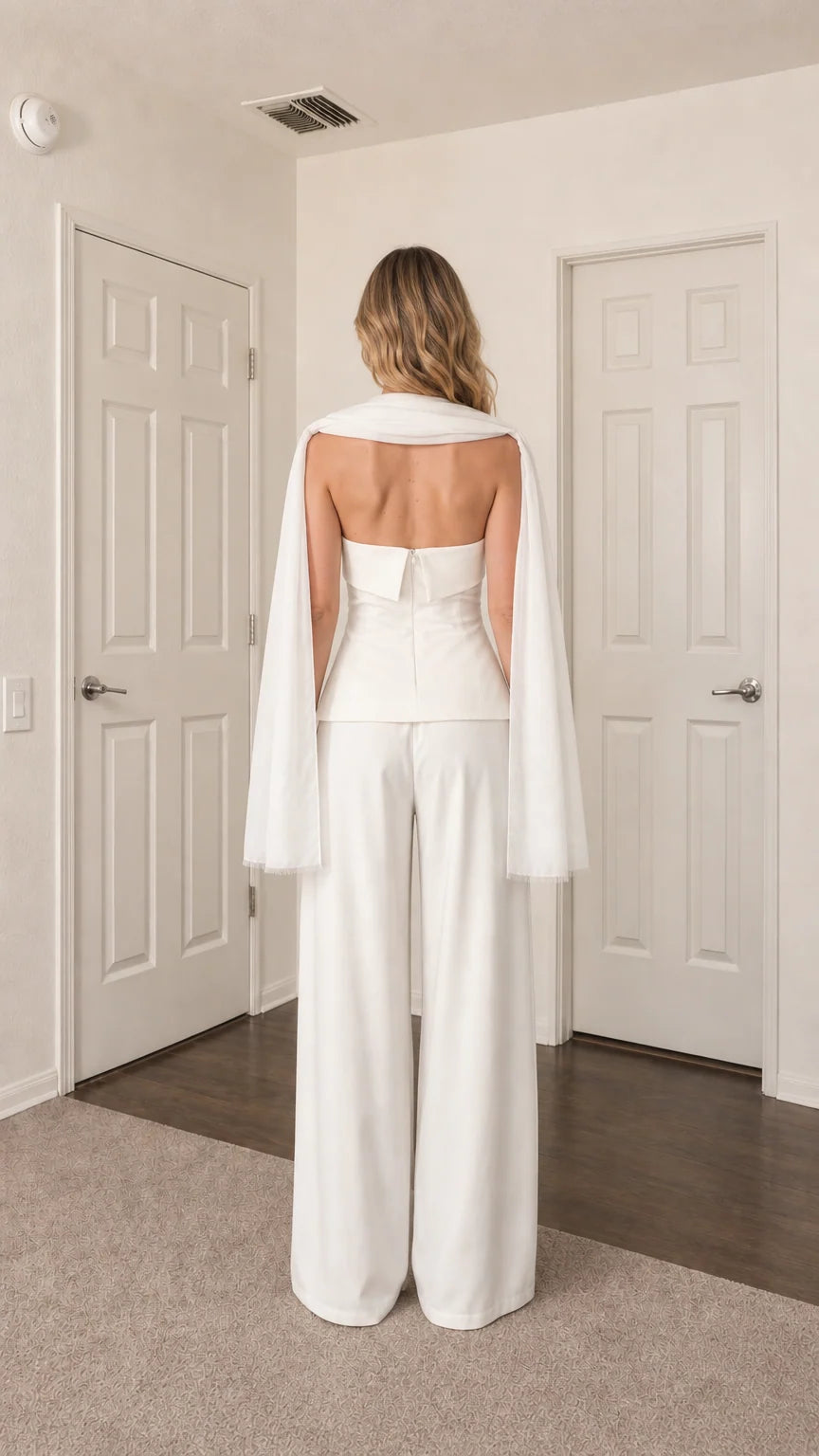 Back view of model in white strapless top and trousers