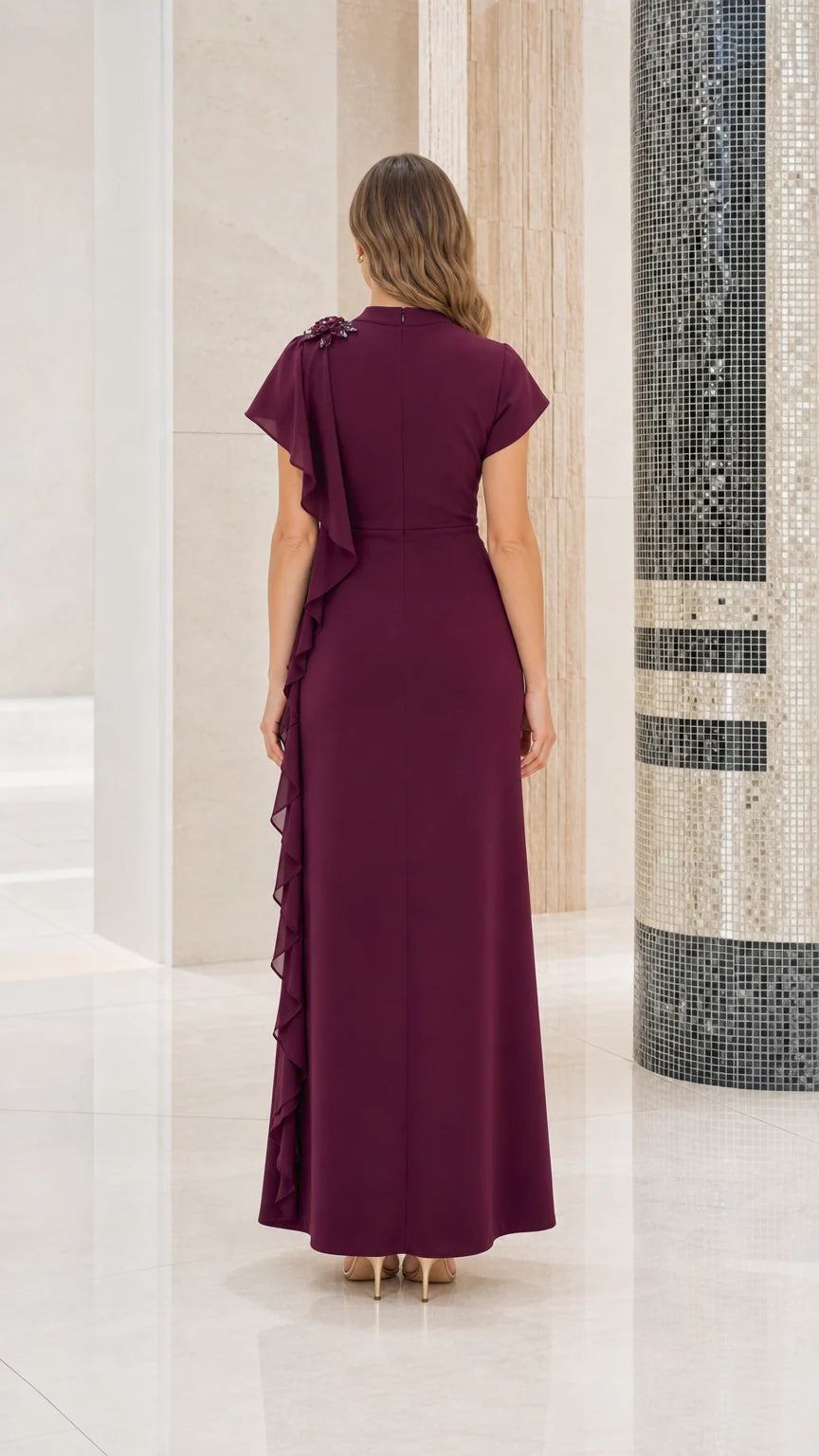 Back view of woman wearing burgundy mock neck formal gown showing smooth back fit