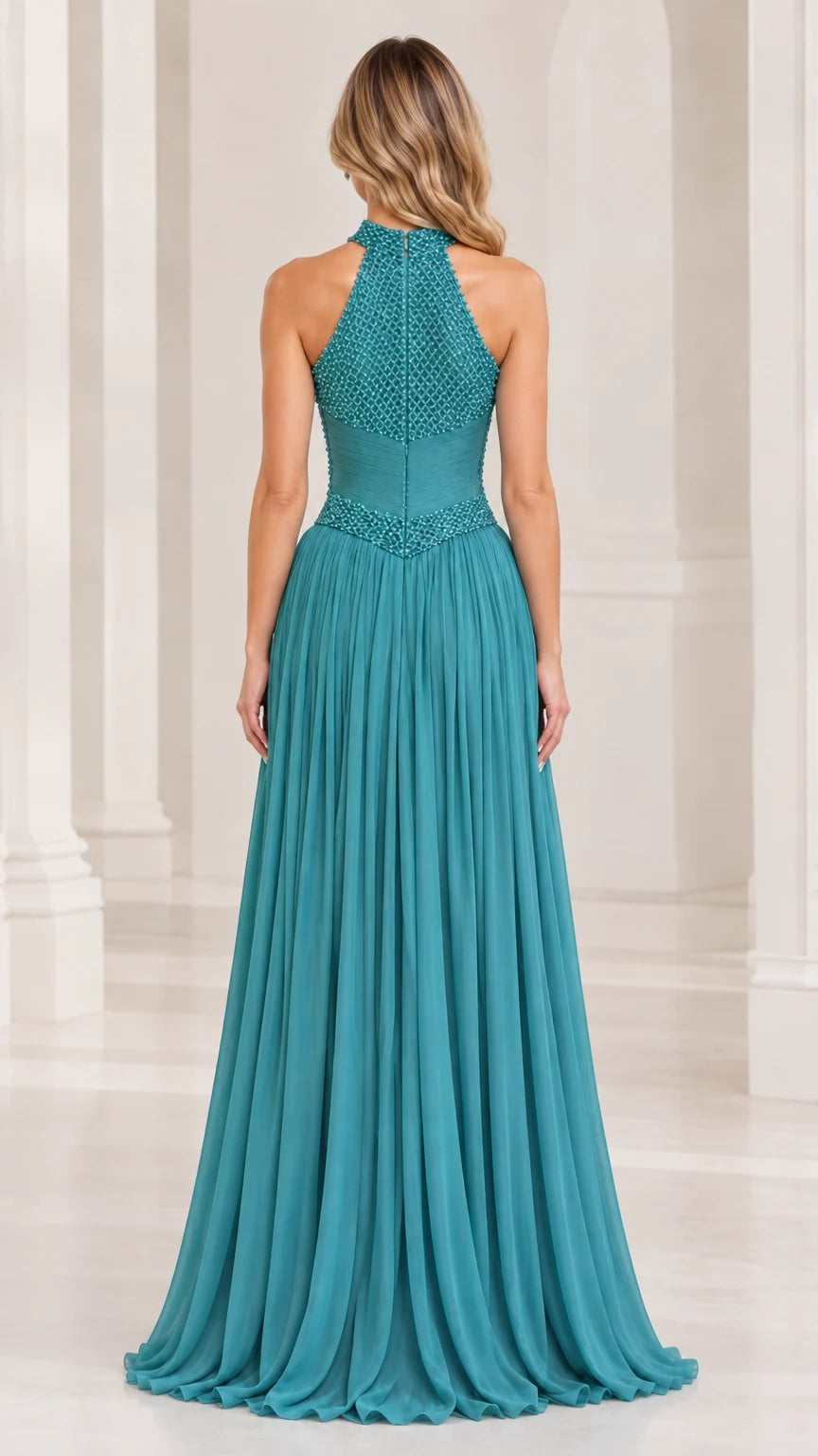 Back view of model wearing a teal halter beaded formal gown with flowing chiffon skirt