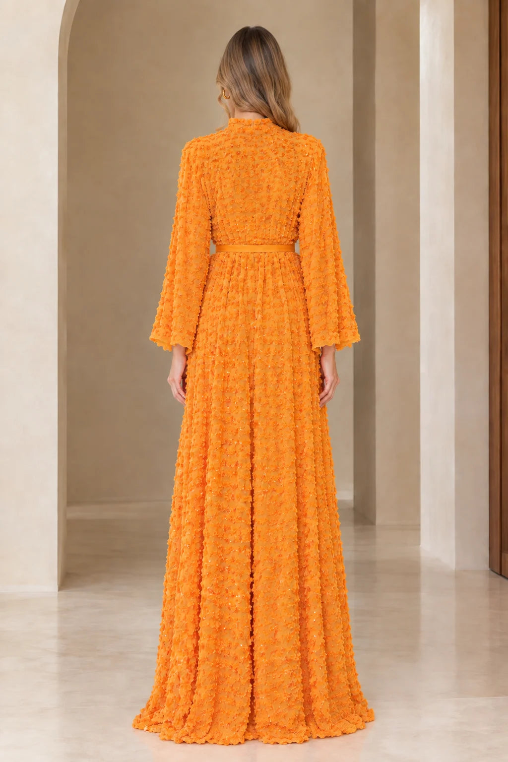 Back full view of long sleeve orange textured sequin maxi dress