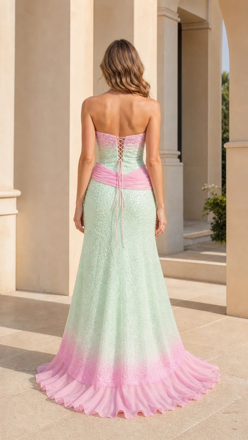 Back view of mint green and pink formal gown highlighting the lace-up corset back and floor-length hem