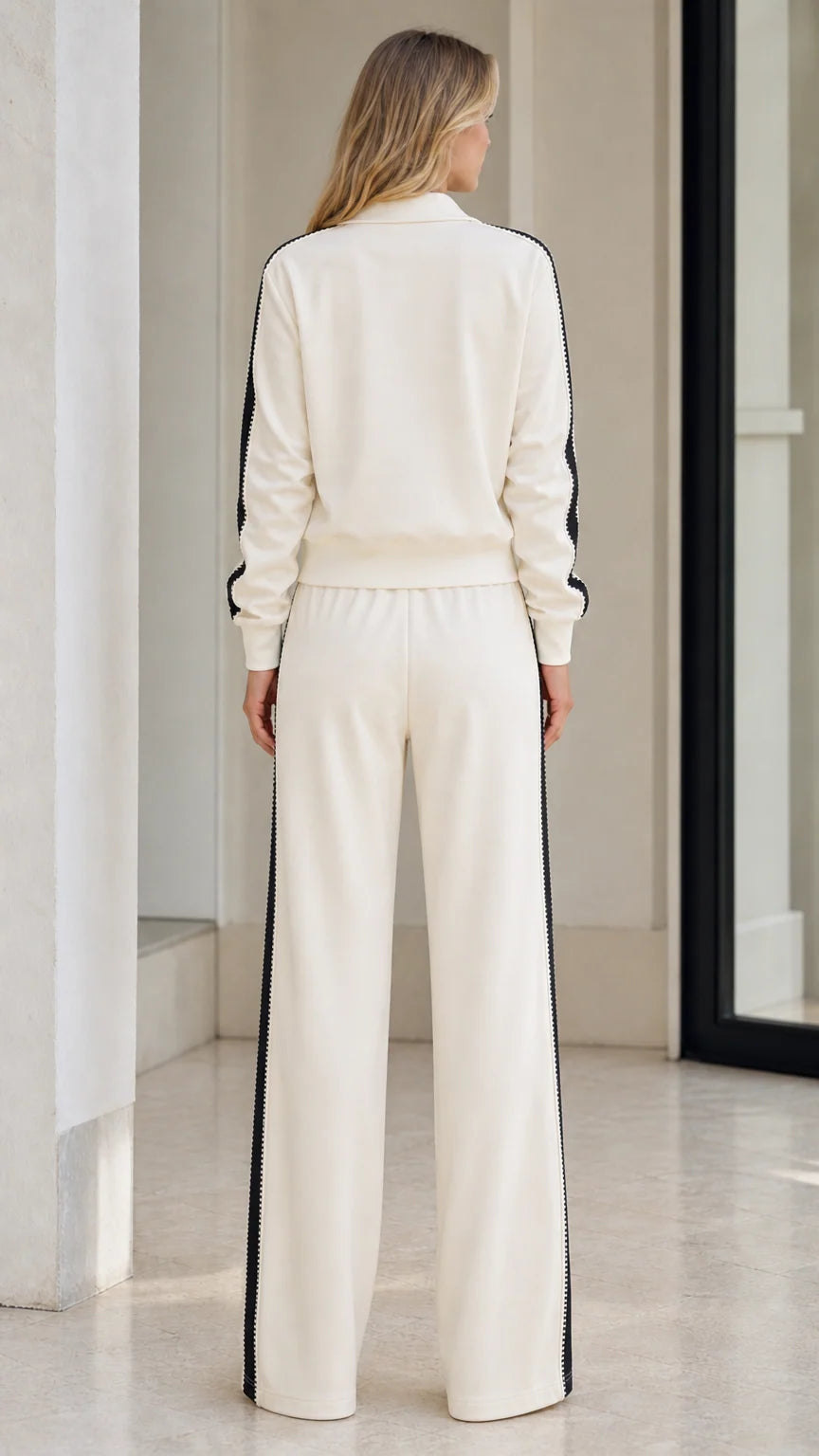 Back view of model in Cream athletic track jacket and wide-leg sweatpants