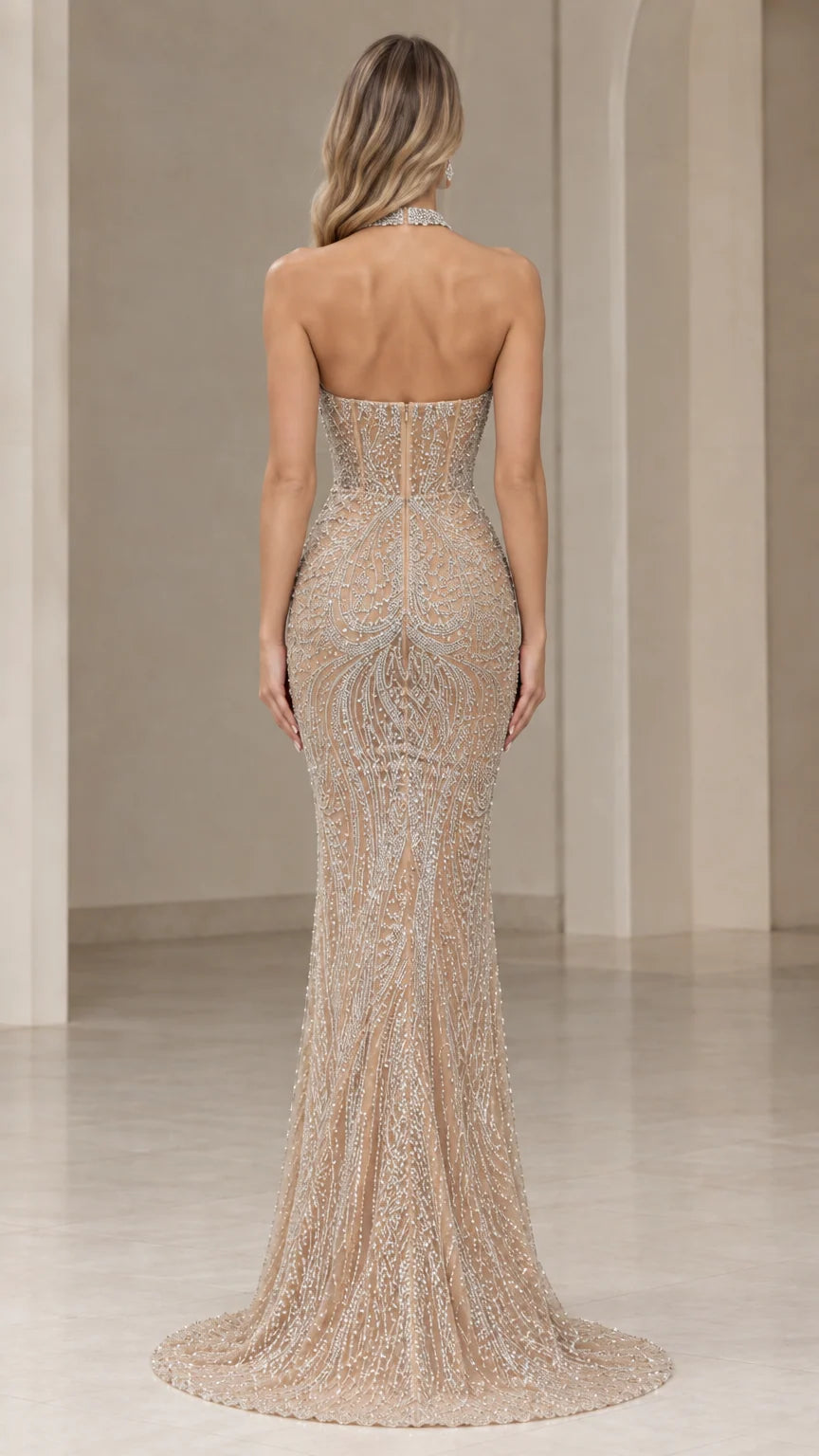 Back view of champagne open back beaded mermaid gown with floor-length train