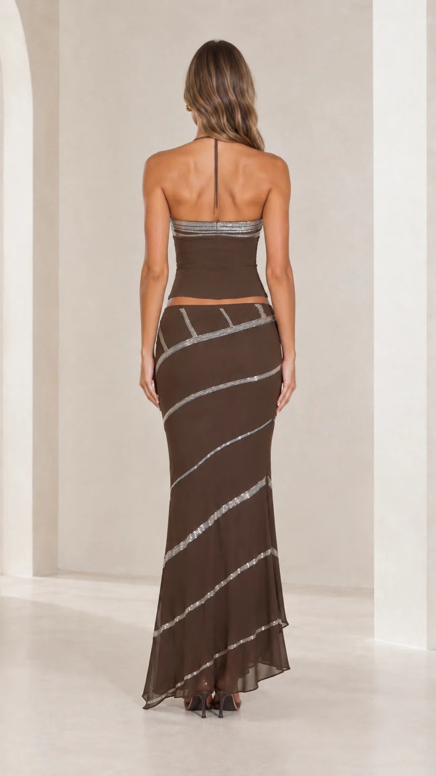 Back view of chocolate brown halter neck crop top and low-rise maxi skirt set