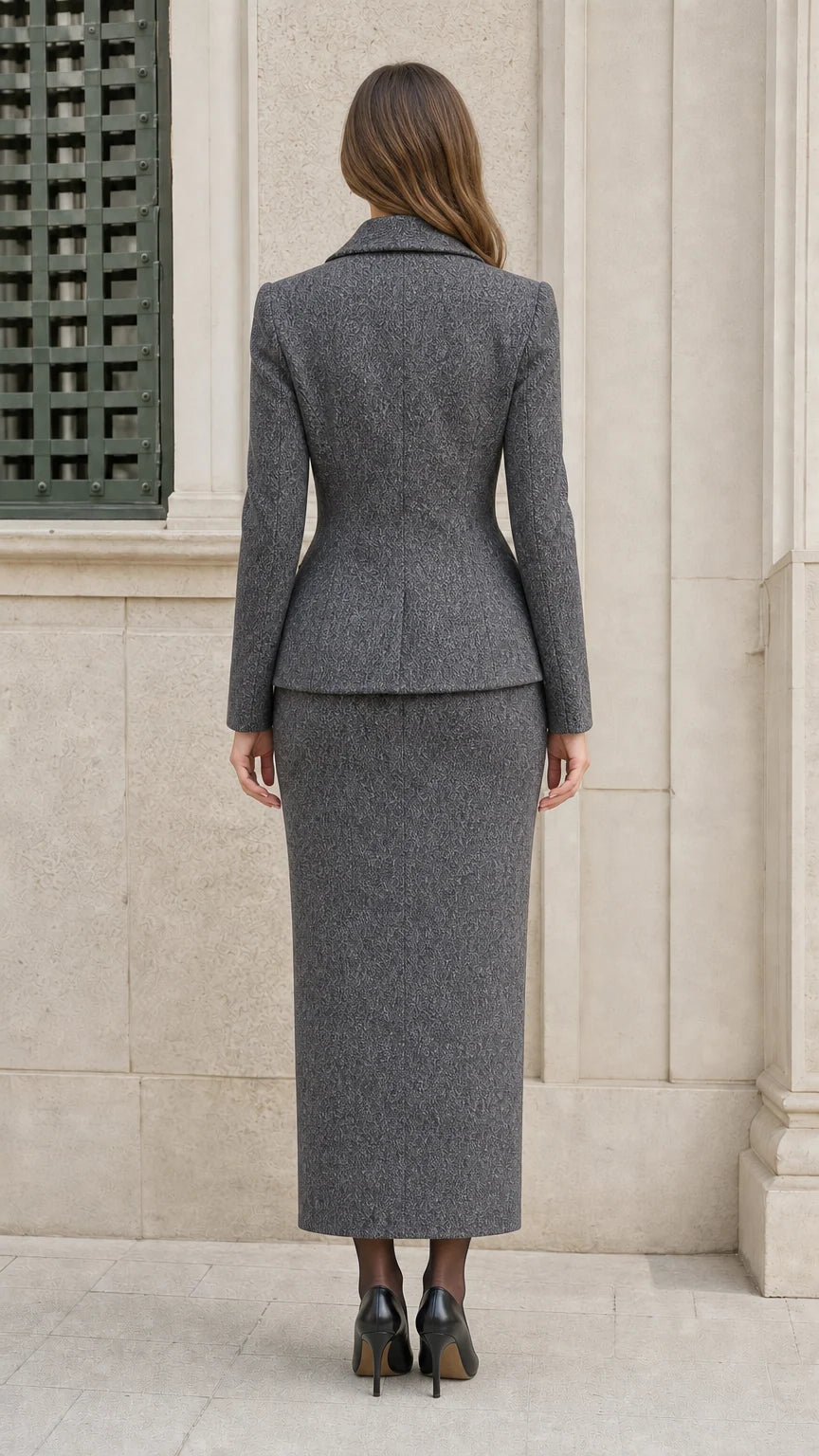 Back view of woman wearing Heather Grey fitted blazer and column maxi skirt
