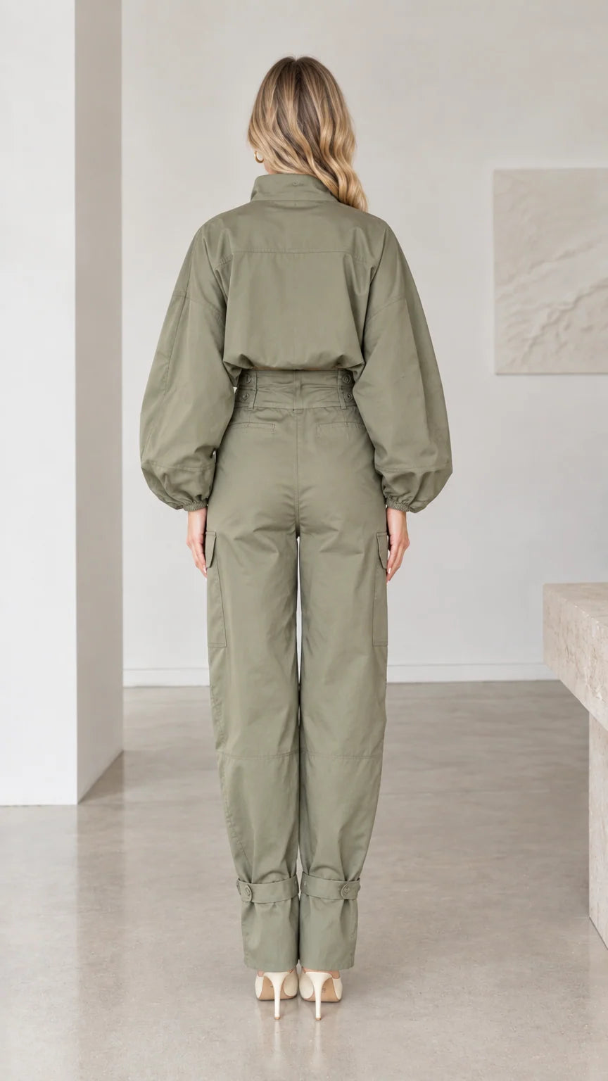 Back full-length view of olive green button-up cargo jumpsuit with tapered legs