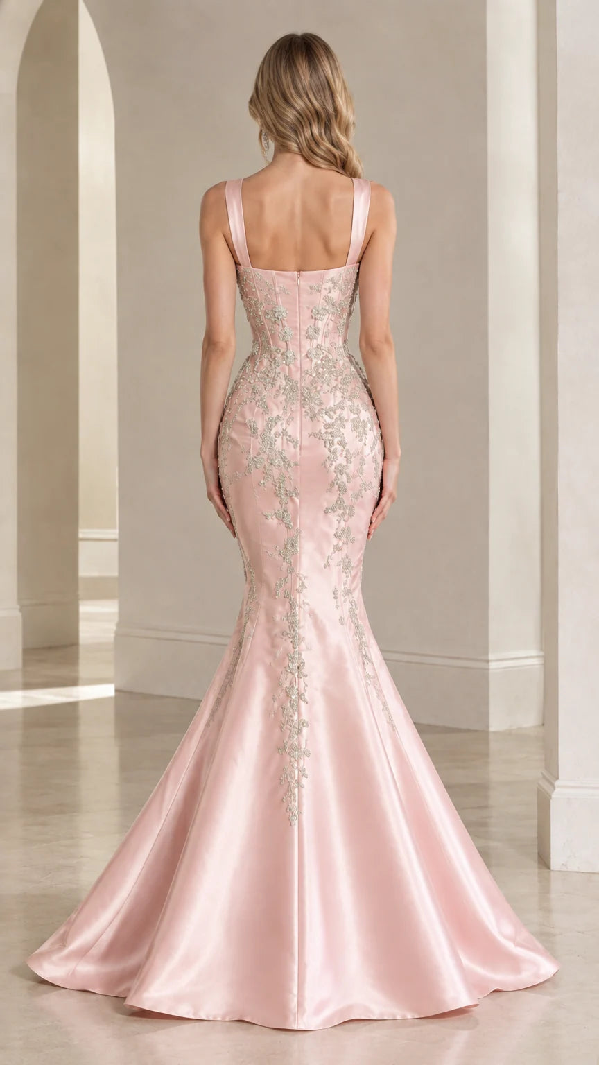 Back view of blush pink corset gown showing flared mermaid skirt and beaded detailing