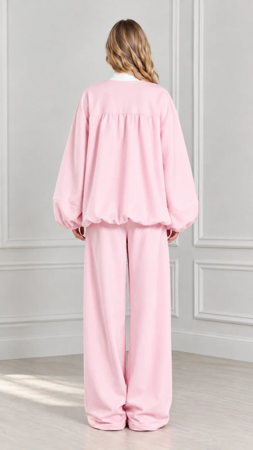Back view of light pink gathered zip-up jacket and matching wide-leg trousers