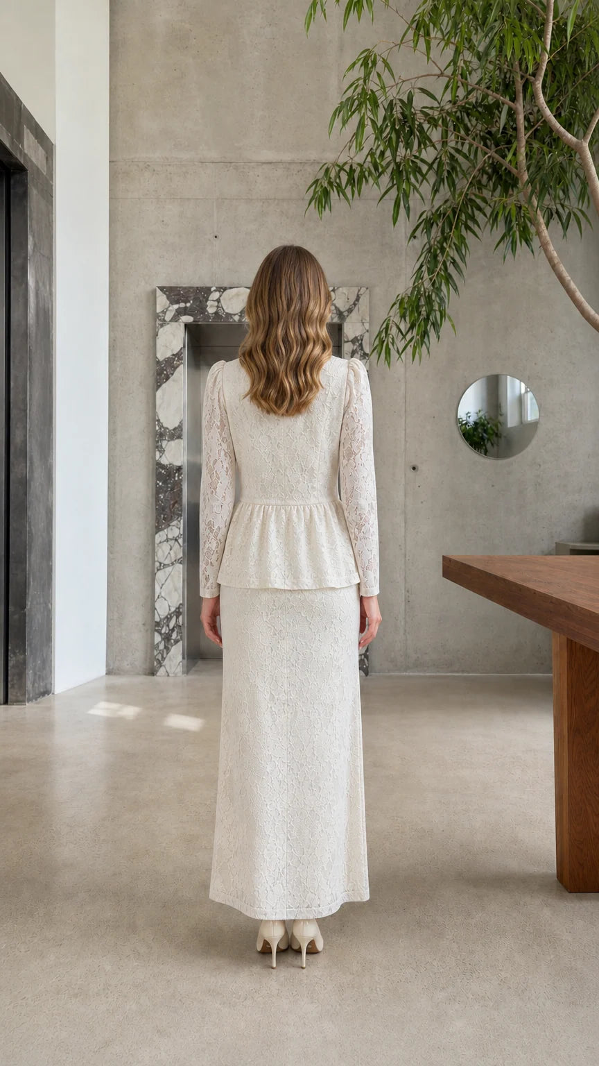 Back view of model wearing the Cream lace peplum top and matching floor-length skirt