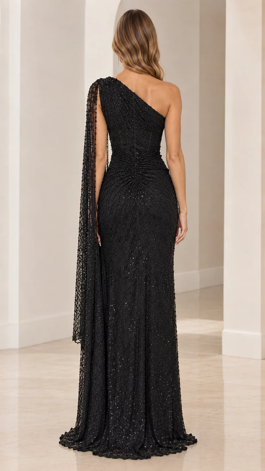 Back view of black sequin one-shoulder formal gown with floor-length hem