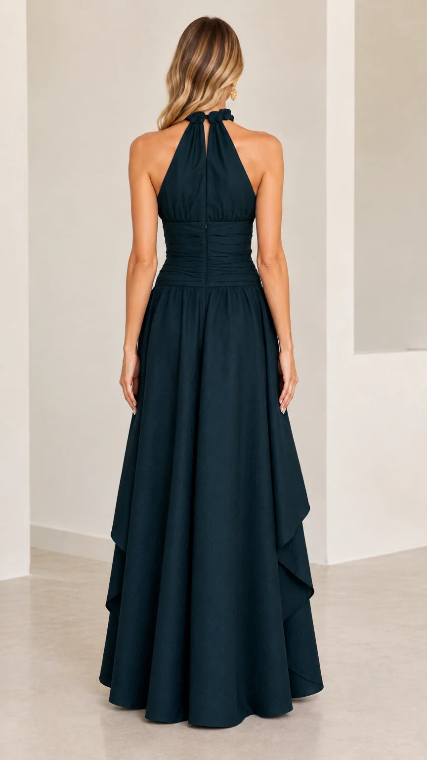 Back view of model in dark green halter evening gown showing high back closure