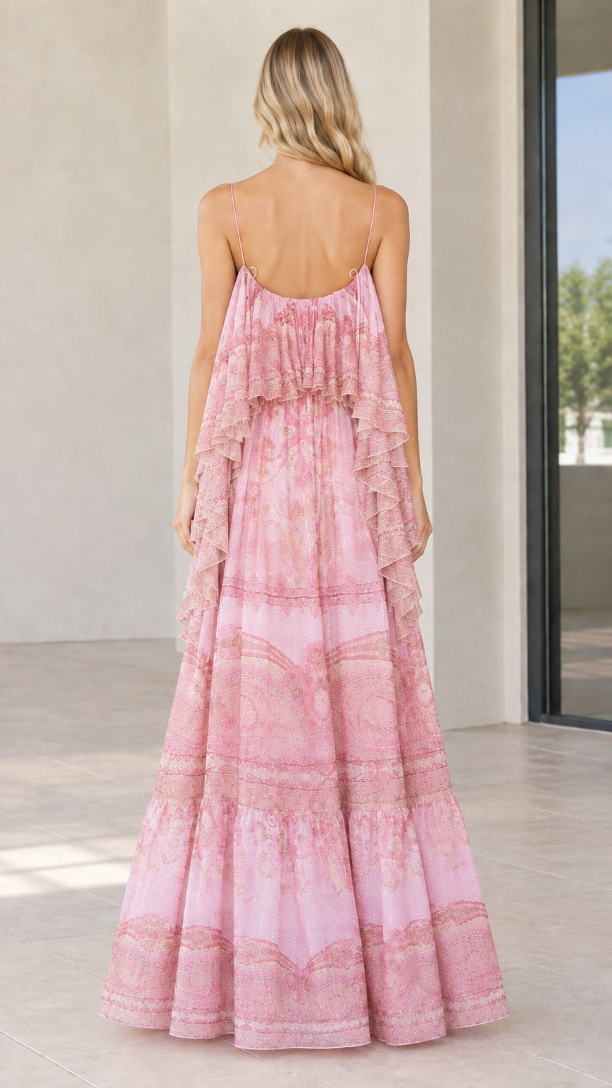 Back view of woman wearing flowy pink paisley floor-length maxi dress
