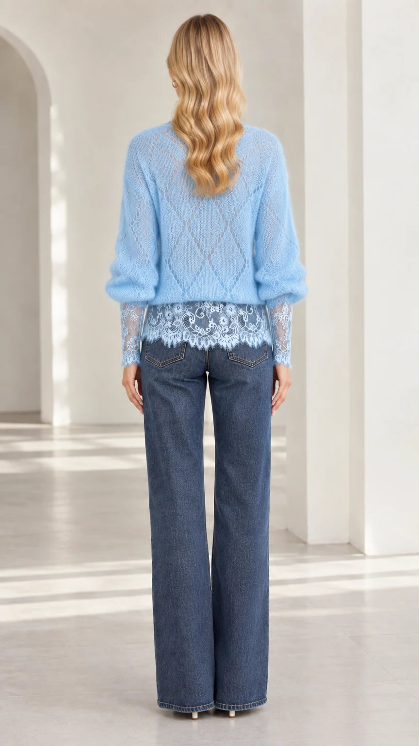 Back view of model wearing light blue diamond knit sweater with lace hem
