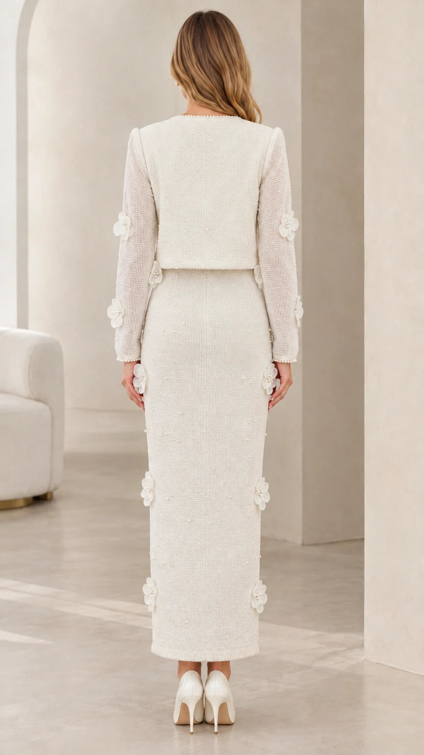 Back view of model wearing ivory tweed cropped jacket and column maxi skirt