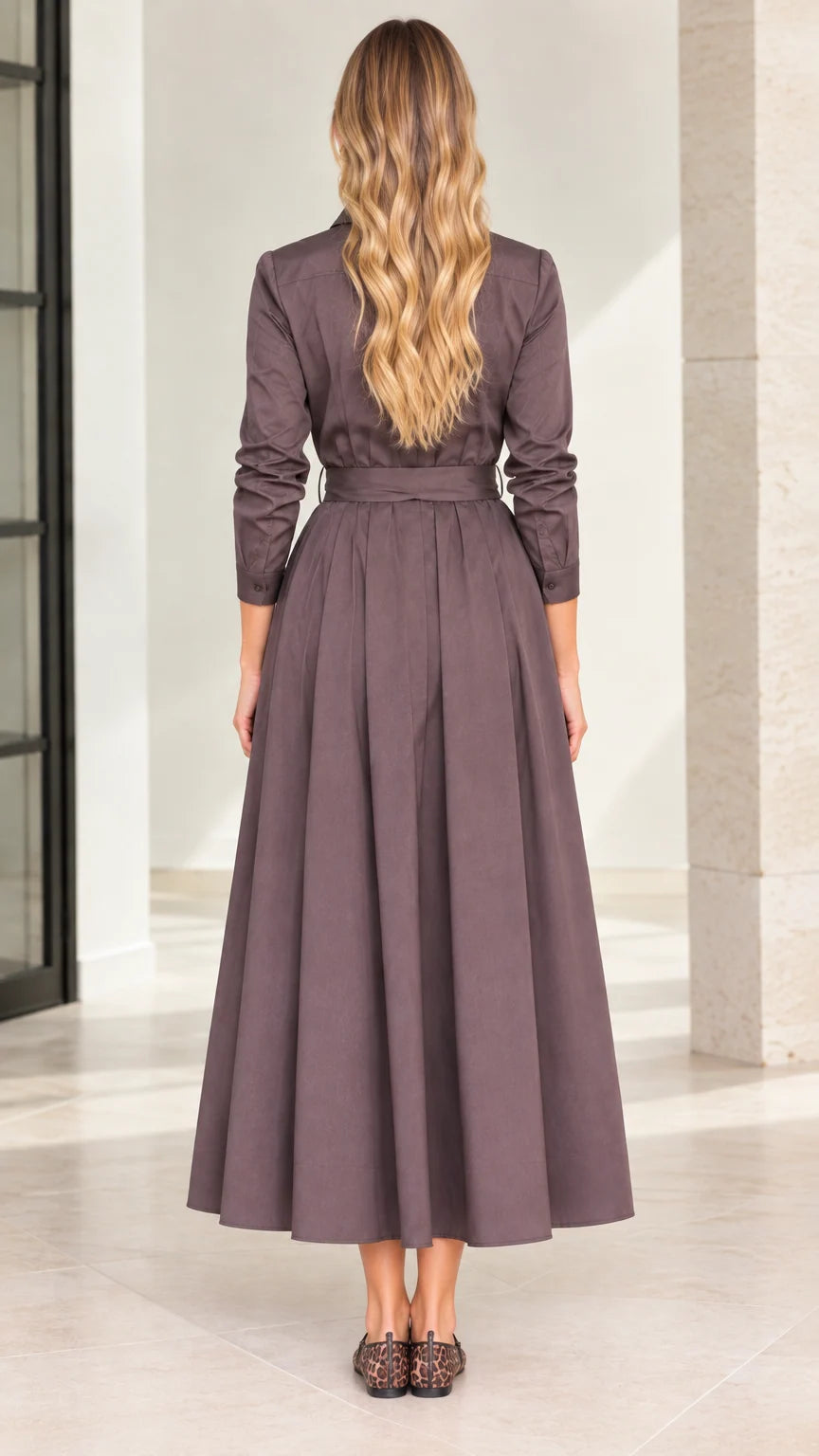 Back view of model wearing mocha brown belted pleated midi shirt dress