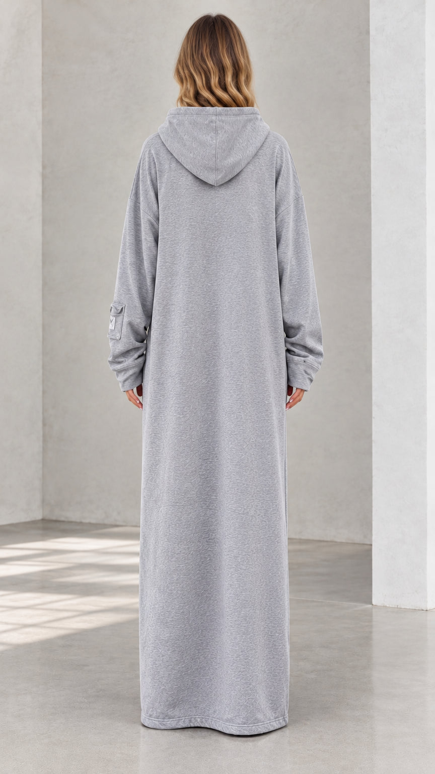 Back view of model wearing heather grey floor-length hoodie dress