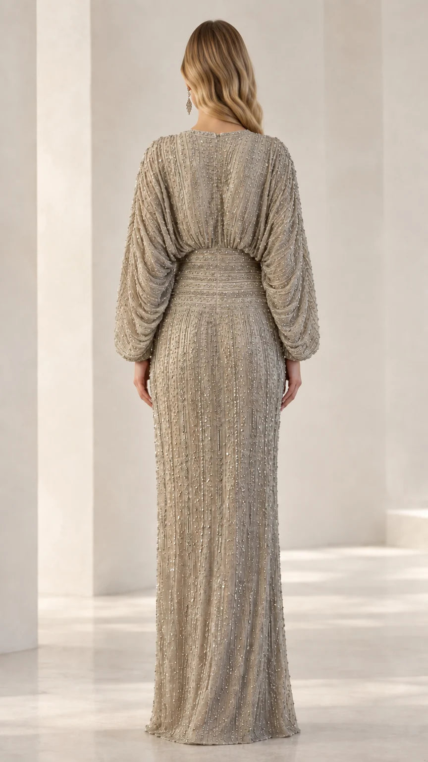 Back view of model in Champagne sequin column gown showcasing fitted waist