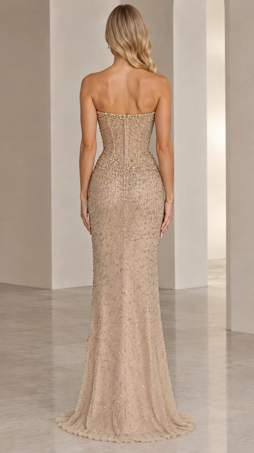 Back view of model wearing Champagne beaded strapless floor-length gown