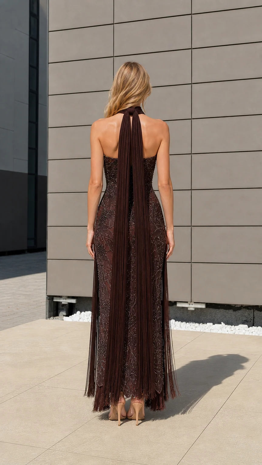 Back view of model showcasing long halter neck drapes on brown gown