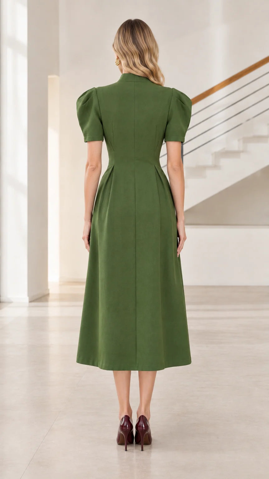 Back view of model wearing olive green fit and flare midi dress with concealed zipper