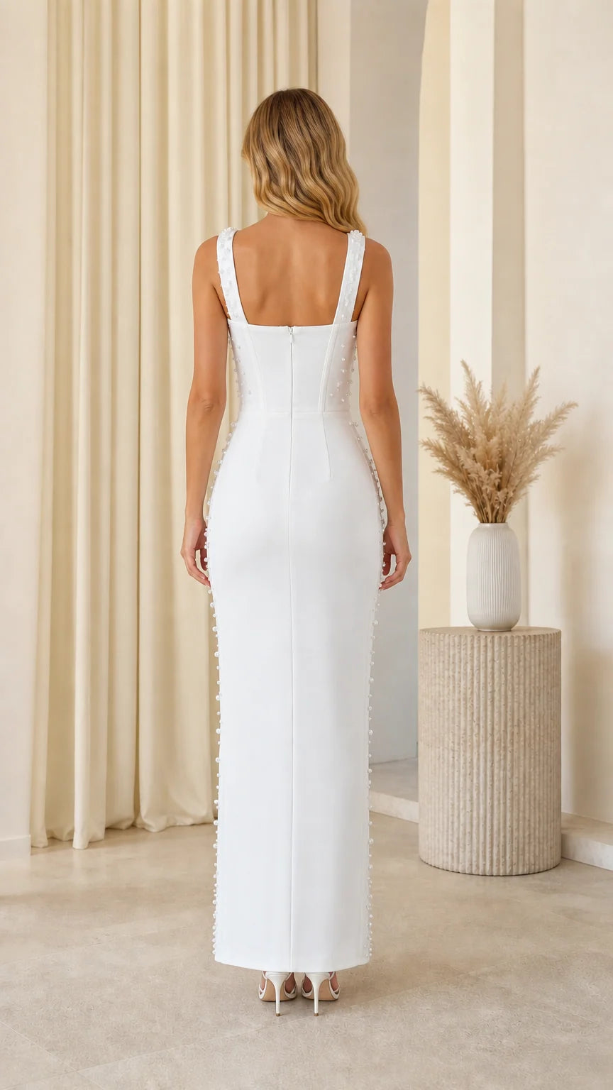 Back view of model in white pearl embellished maxi dress