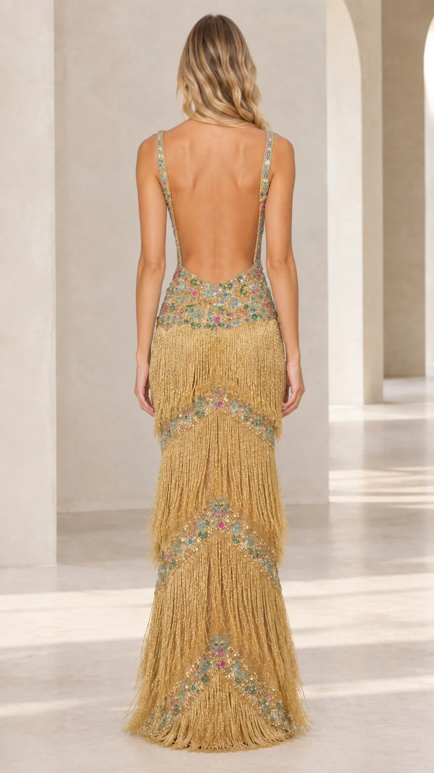 Back view of gold fringe maxi gown showing open back silhouette