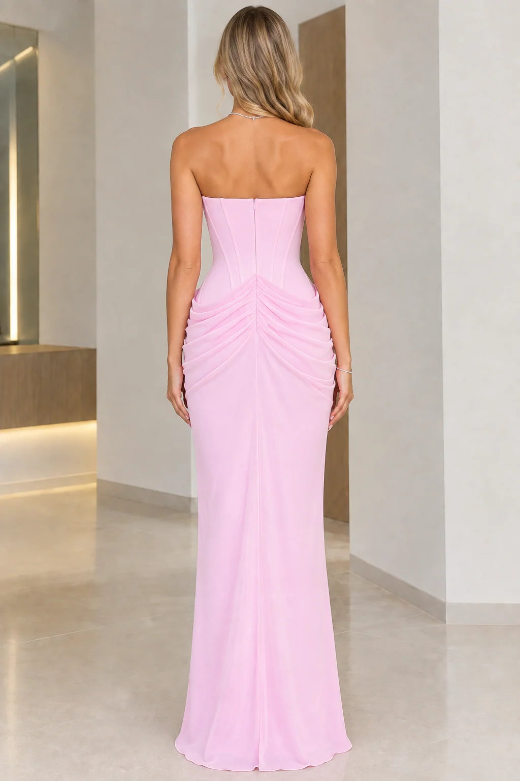 Back view of model wearing Light Pink strapless maxi gown