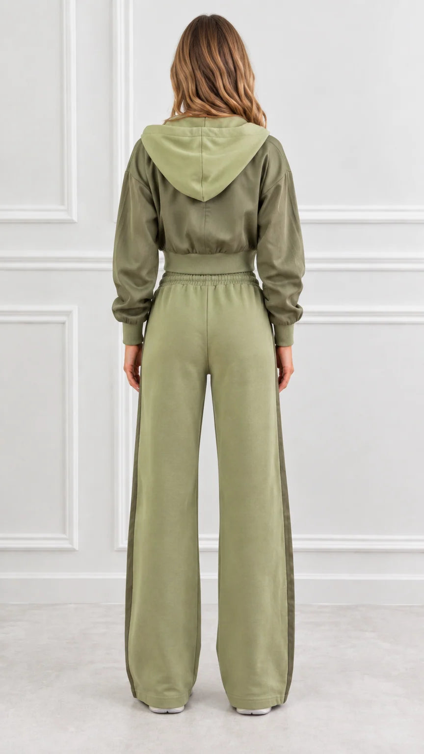 Back view of woman wearing olive green cropped hoodie with hood and matching wide-leg pants