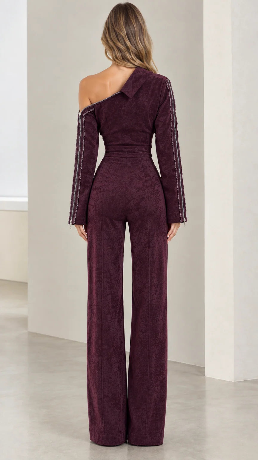 Back view of model in Burgundy asymmetric one-shoulder wide-leg jumpsuit
