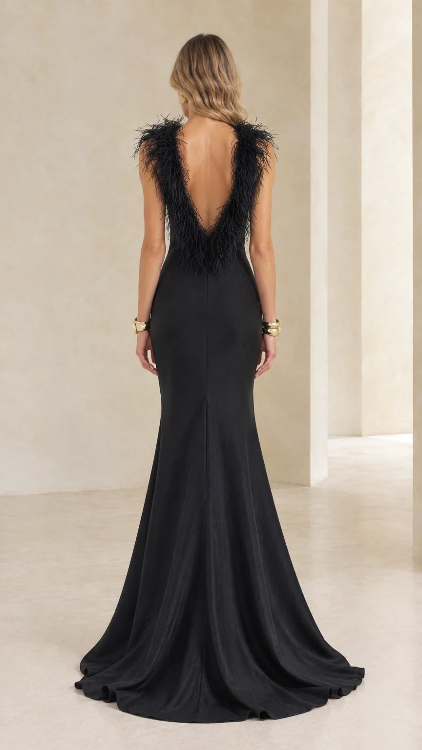 Black mermaid evening dress showing deep V-back with feather trim and train
