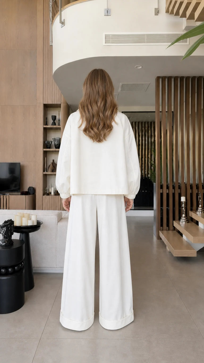 Back view of the white cropped blazer and matching wide-leg trousers