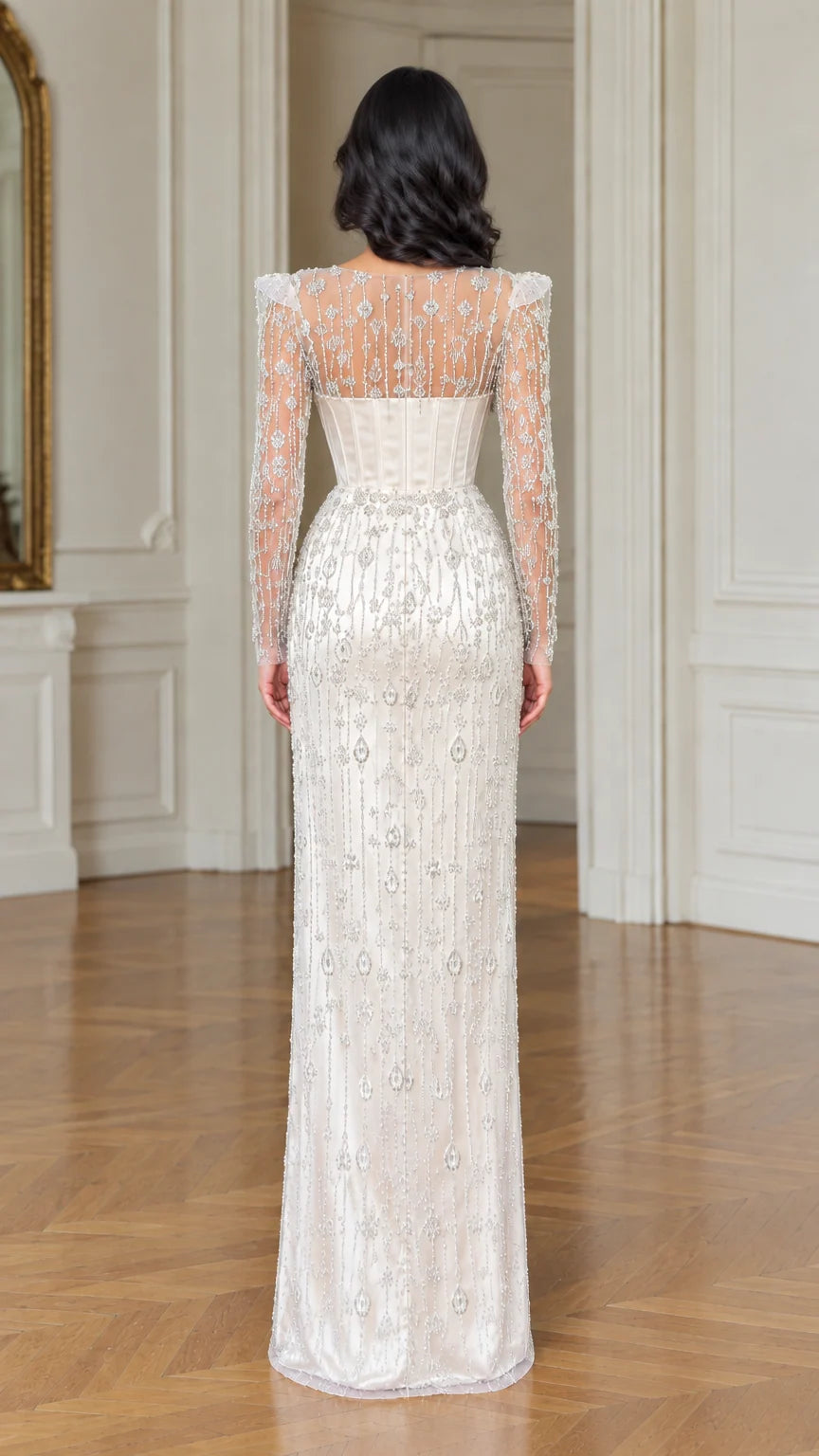 Back view of ivory illusion beaded long sleeve corset evening dress
