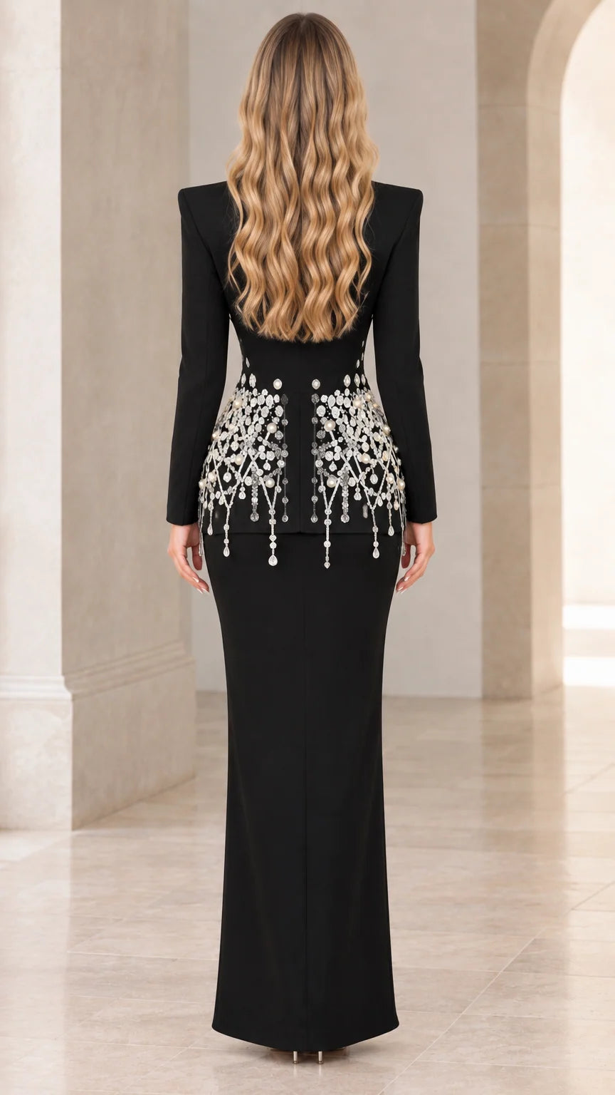 Back view of model showing tailored fit and embellishments of black skirt suit set