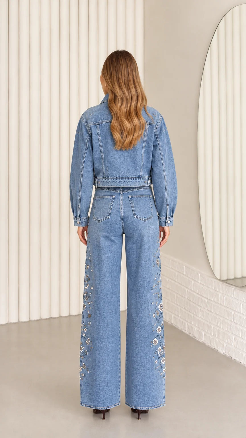 Back view of model wearing Light Blue cropped denim jacket and wide-leg pants