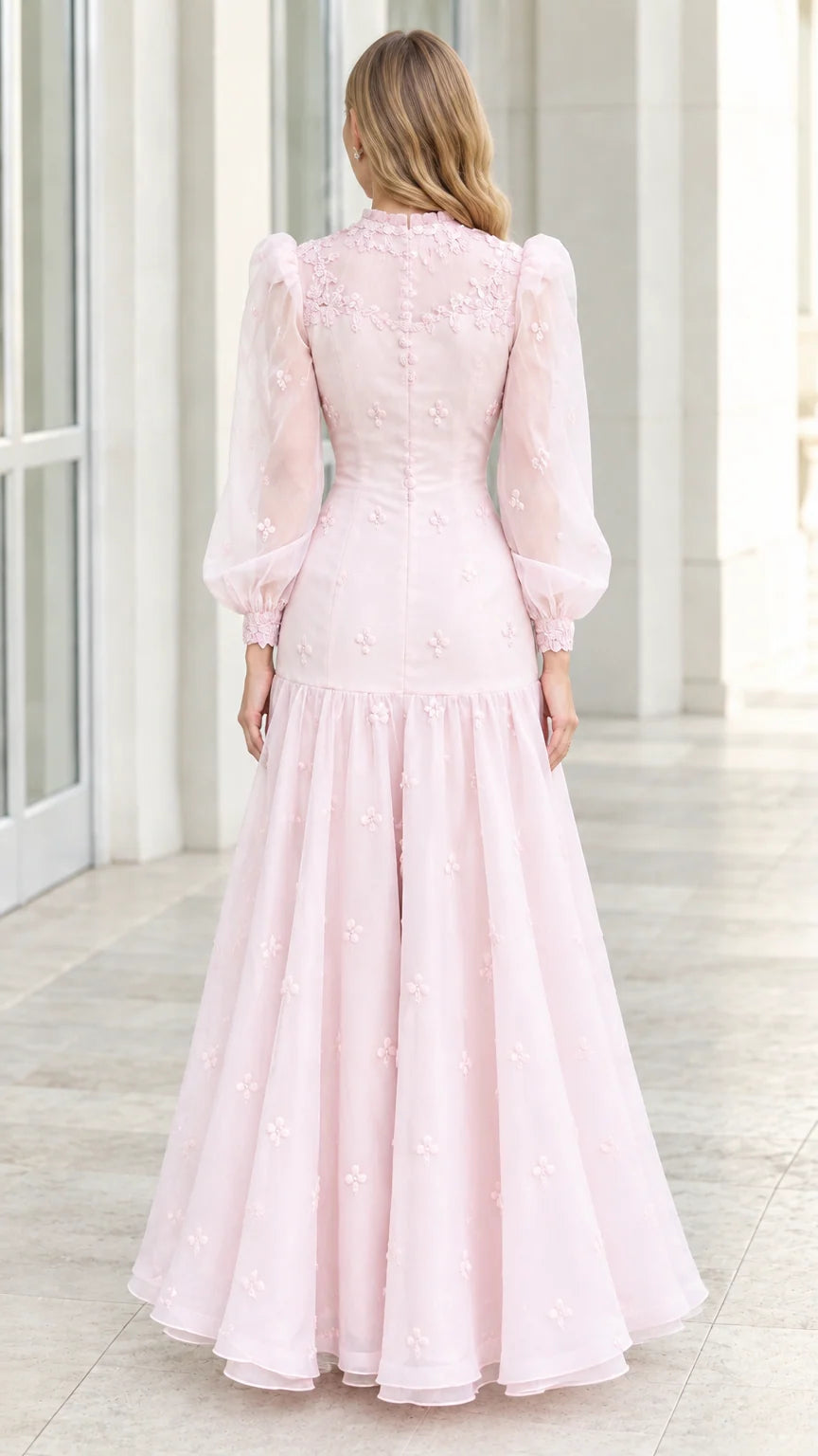 Back view of model wearing blush pink long sleeve formal evening gown