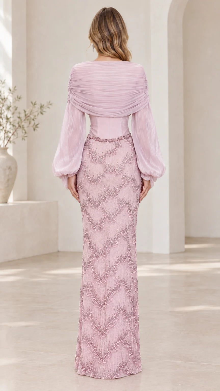Back view of dusty pink draped bodice long sleeve formal gown