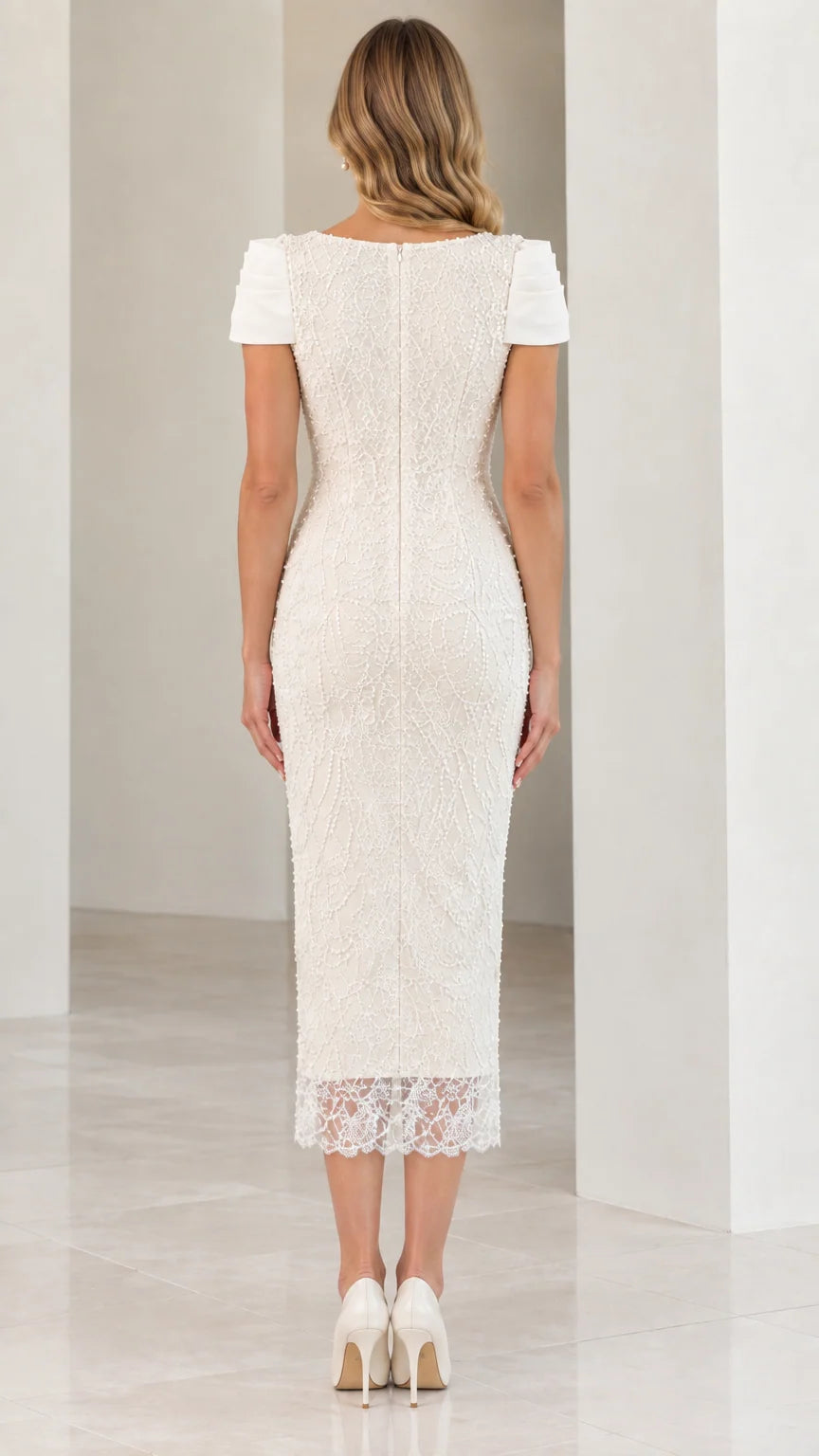 Back view of woman wearing Ivory beaded midi dress showing back zipper and walking slit