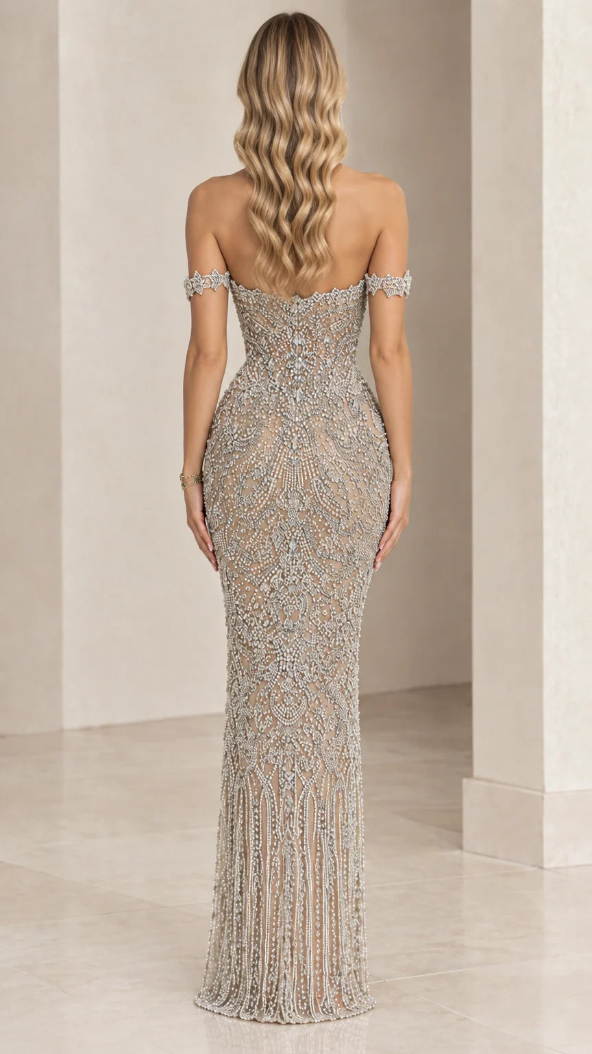 Back view of fitted champagne beaded gown showing off-the-shoulder neckline