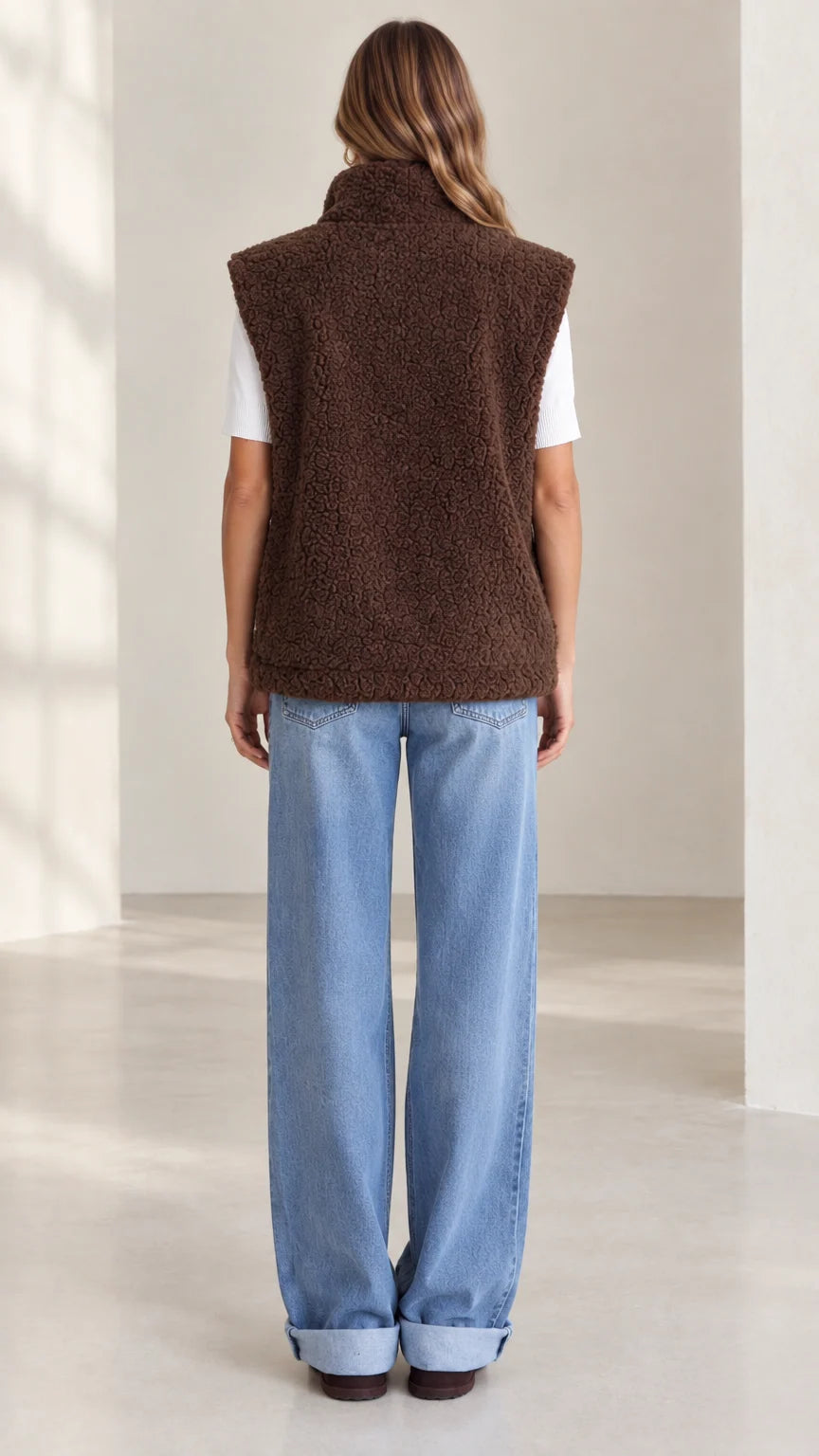 Back view of woman wearing brown plush sherpa fleece vest