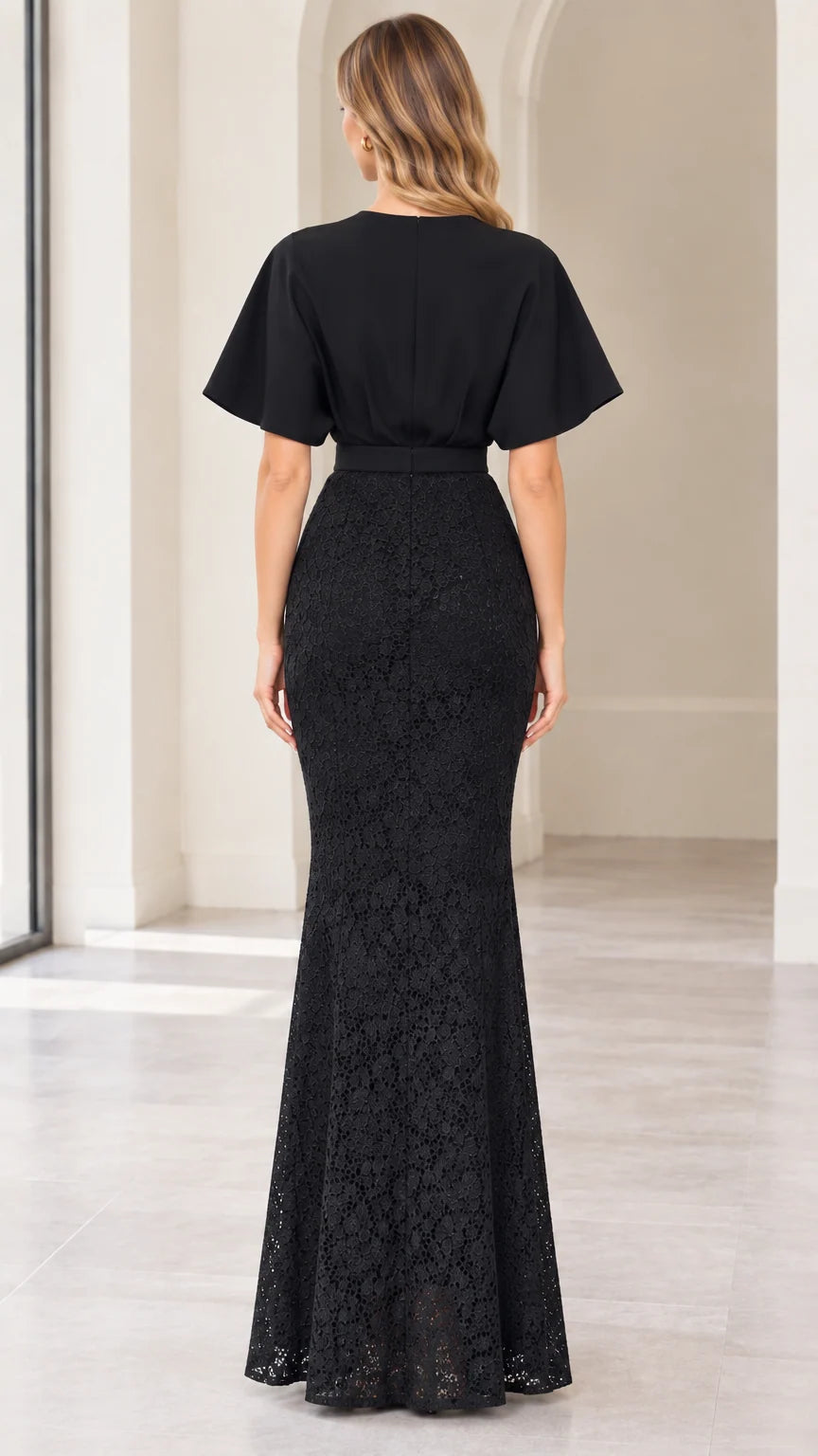 Back full-length view of black flutter sleeve lace maxi gown