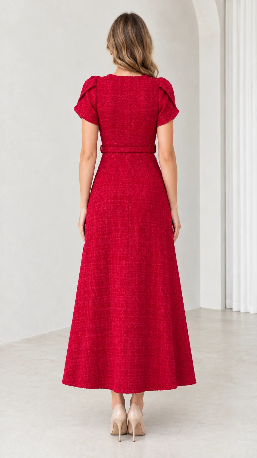 Back view of woman wearing tailored red A-line midi dress with matching belt