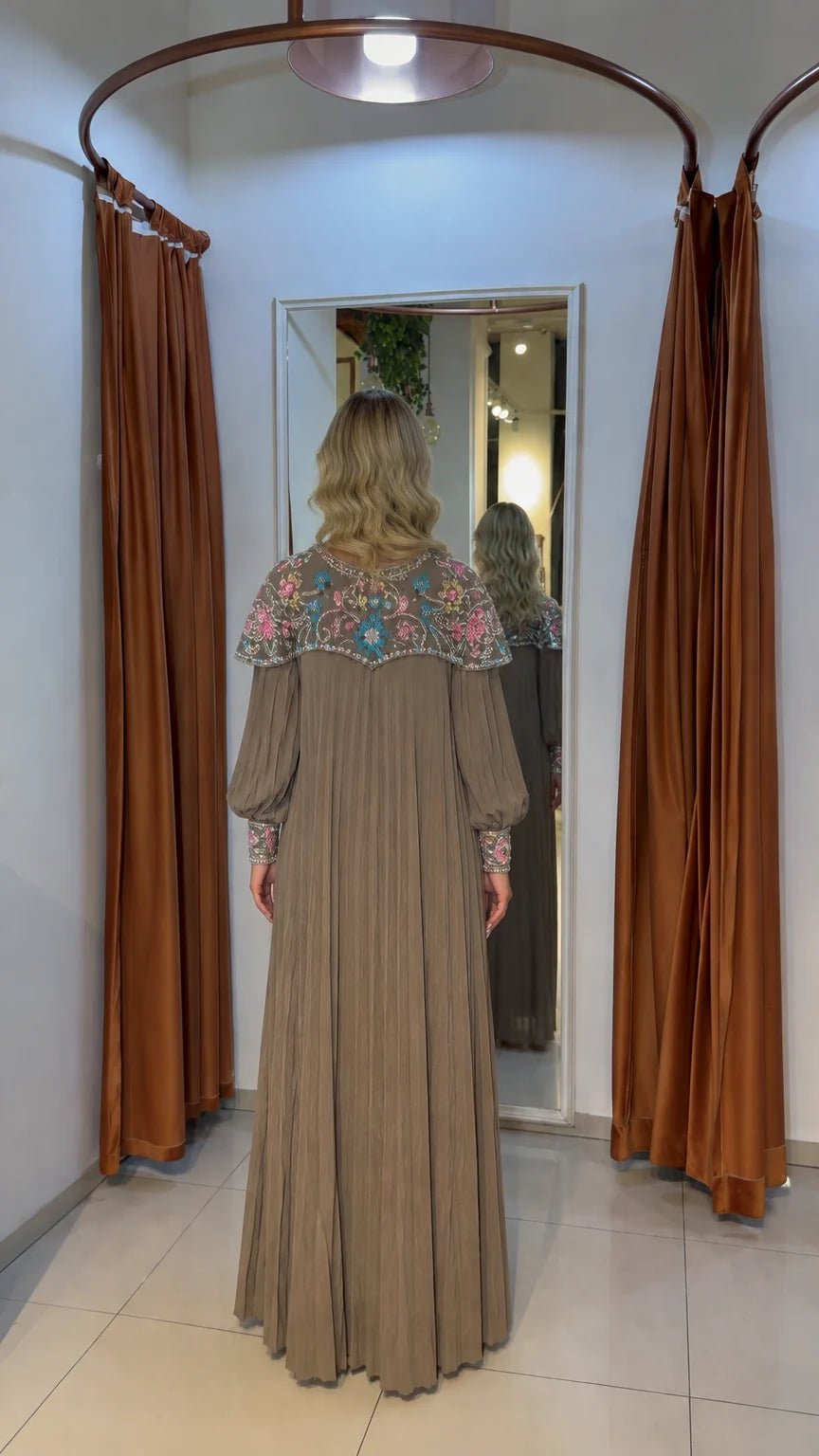 Back view of mocha pleated maxi dress highlighting embellished collar