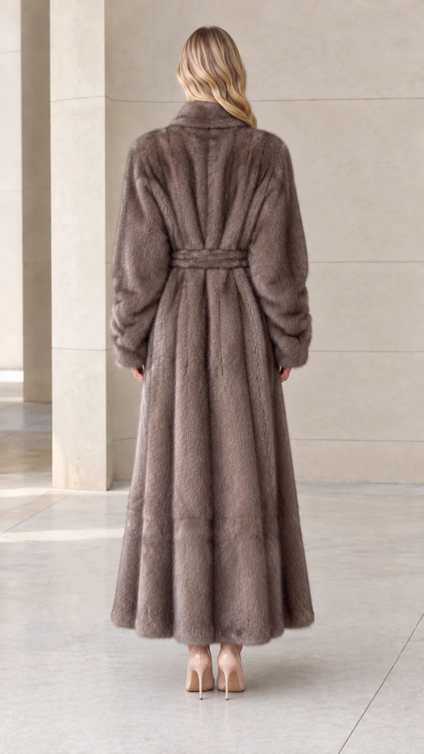 Back view of woman wearing long taupe plush coat with belted waist