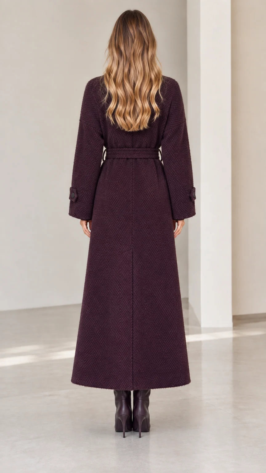 Back view of woman wearing deep plum herringbone maxi coat