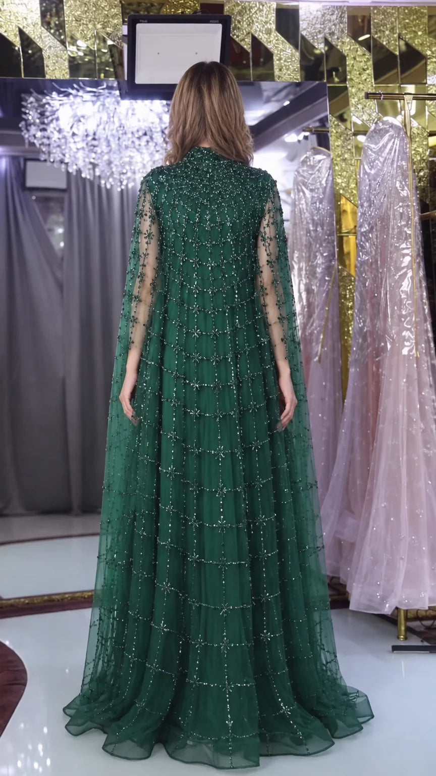 Back view of emerald green high neck beaded cape evening dress