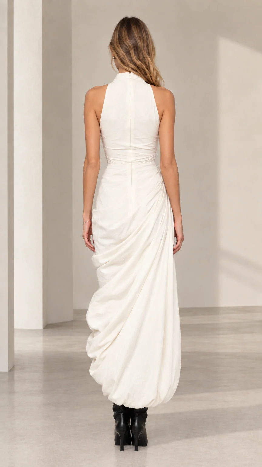 Back view of model wearing ivory high neck fitted bodice maxi dress