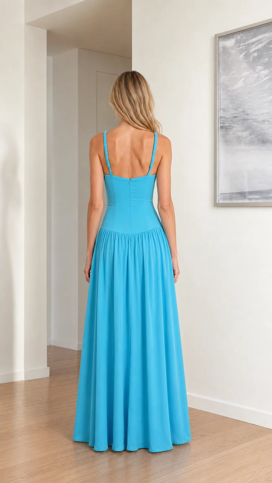 Back view of model in sky blue square back drop waist evening gown